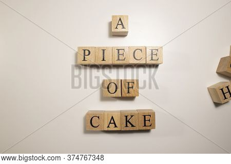 In Terms Of Easy Work, A Piece Of Cake. Written From Wooden Cubes.