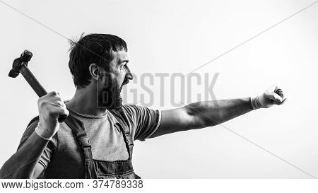 Screaming Foreman Holding Hammer. Brutal Man Hammering. Construction Work. Bearded Builder Working W