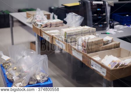Carton boxes filled with sorted money and stored in the treasury department   sorting and counting money inside bank vault