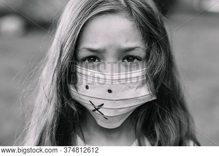 A Girl In A Medical Mask From Protection Against Covid-19.