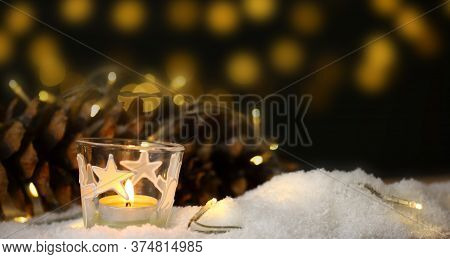 Christmas Theme With Candles, Snow, Pine Cone And Christmas Light