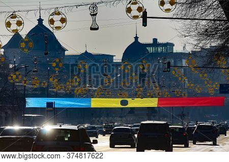 Bucharest, Romania - December 22, 2019: A Romanian Flag With A Hole In The Middle Is Displayed Near 