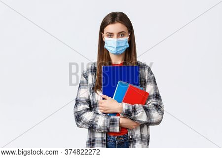 Coronavirus Pandemic, Covid-19 Education, And Back To School Concept. Young Female Student In Medica