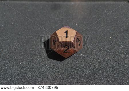 Copper Metallic D12 Twelve Sided Dice On Foam Surface