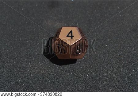 Copper Metallic D12 Twelve Sided Dice On Foam Surface