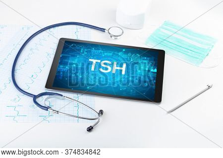 Close-up view of a tablet pc with TSH abbreviation, medical concept