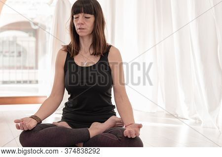 Yoga Teacher Sitting In The Lotus Position. Woman Practicing Yoga. How To Keep Your Arms  For A Kriy