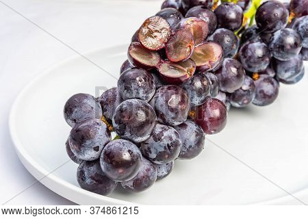 Kyoho Plump Kyoho Grapes (giant Mountain Grapes) Isolated On White In A Dripping Dish, Sweet And Del