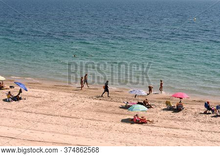 Orihuela, Costa Blanca, Spain - September 21, 2018:people Relax On The Sandy Beach Of Playa De Aguam