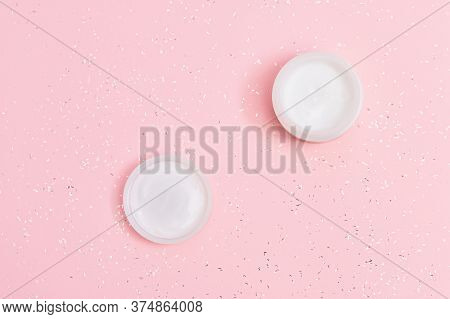 Open White Jar Of Facial Moisturizer On Pink Paper Background. Cosmetics For Face. Skincare Product 
