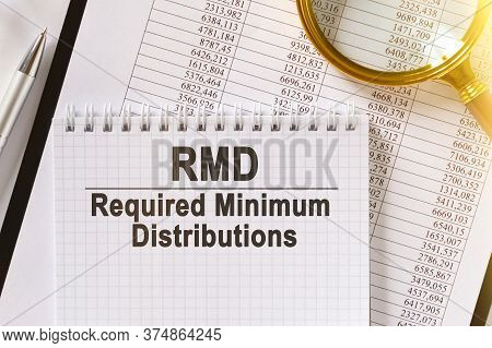 On The Table Are Financial Reports, A Pen, A Magnifying Glass And A Notebook With The Inscription - 