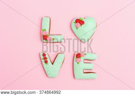 Gingerbread Heart, Cookies In Shape Of Letter Love With Icing On Pastel Pink Background. Valentines 