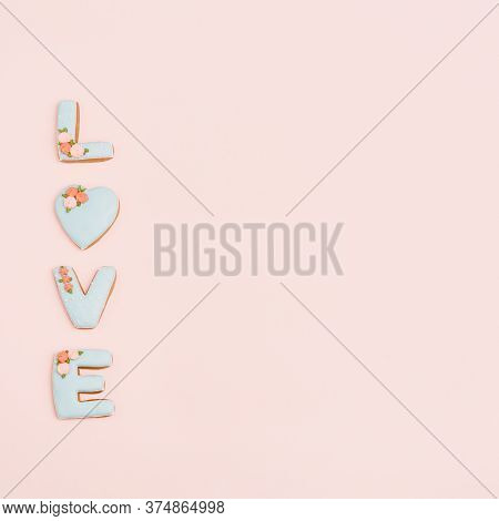 Gingerbread Heart, Cookies In Shape Of Letter Love With Icing On Pastel Pink Background. Valentines 