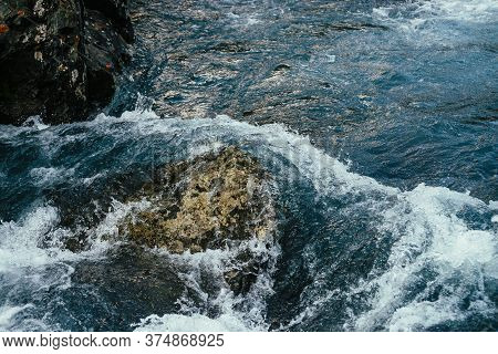 Big Stones In Azure Water Of Mountain River Close-up. Blue Nature Background With Big Boulders In Tu