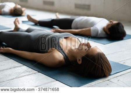 Young Beautiful Fit Woman Resting In Dead Body Corpse Position.