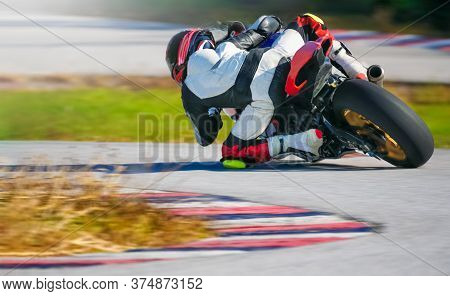 Motorcycle Leaning Into A Fast Corner On Race Track
