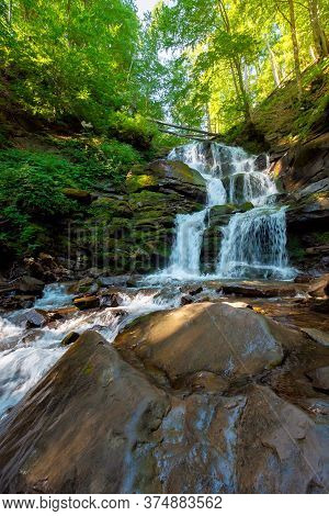 Great Water Fall In The Forest. Beautiful Nature Landscape. River Among The Rocks. Fresh Summer Scen