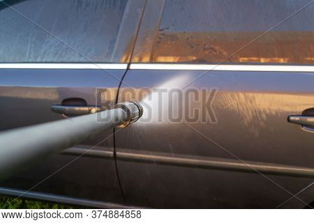 Car Wash, A Woman In Blue Gloves Washes A Car With A Karcher