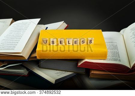 The Concept Of Useless Knowledge. Useless - Word From Wooden Blocks