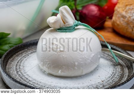 Eating Of Fresh Handmade Soft Italian Cheese From Puglia, White Balls Of Burrata Or Burratina Cheese