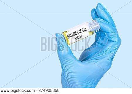 Pneumococcal Vaccine Text Is Written On A Vial Whose Ampoule Is Held By A Hand In A Medical Disposab
