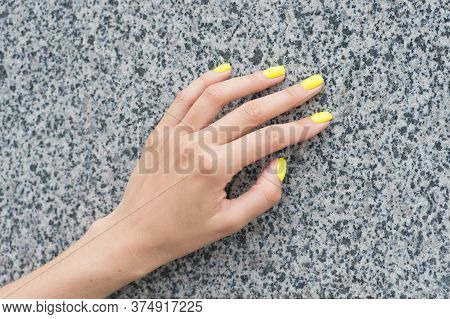 Professional Nail Care. Female Hand With Yellow Nail Color. Applying Nail Lacquer. Nail Salon Manicu