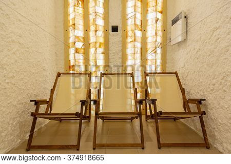 Three Deck Chairs In A Salt Bath Room.