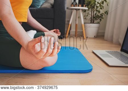 Young Caucasuan Woman Doing Yoga At Living Room