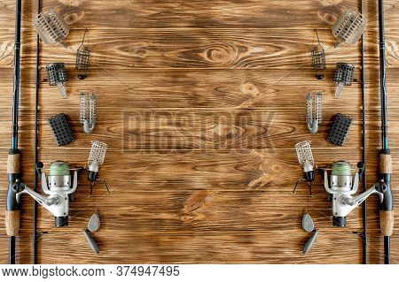 Flat Lay With Fishing Tackle, Fishing Rod And Plastic Box With Fishing Tackle And Hooks, Feeders On 