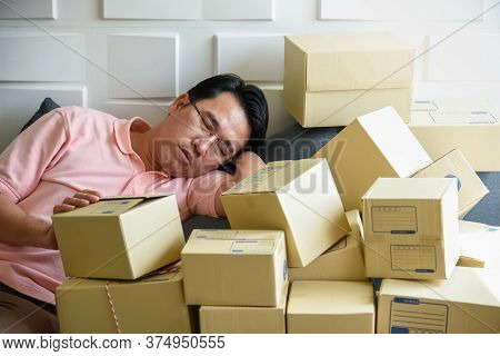 Asian Men Are Falling Asleep Because To Tired Of Handling The Order-based Goods From Online Customer
