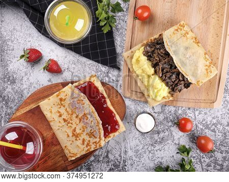 Shrovetide Maslenitsa. Traditional Festival Meal. Pancakes Blini With Meat And Berry Jam, Flat Lay B