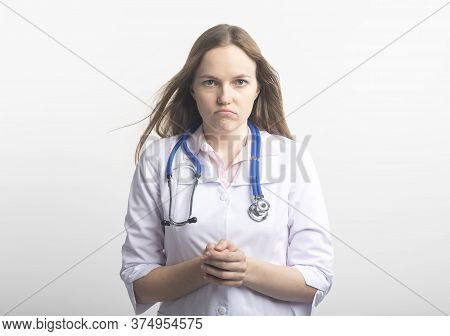 Female Doctor Giving Bad News On White Isolated Background. Sad Doctor After Failure