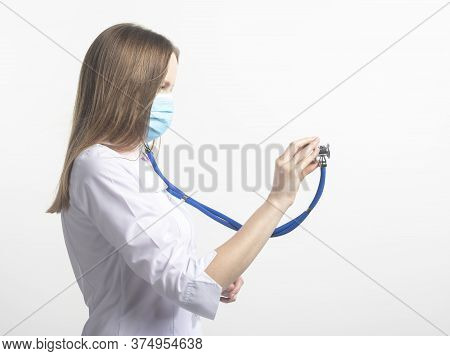 Close Up Portrait Of Caucasian Doctor Woman In Face Mask With Stethoscope Using In Aside Direction I