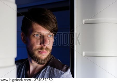Handsome Young Caucasian Man With A Beard Portrait, Looks Outside Of The Trains Window, Looking Bore