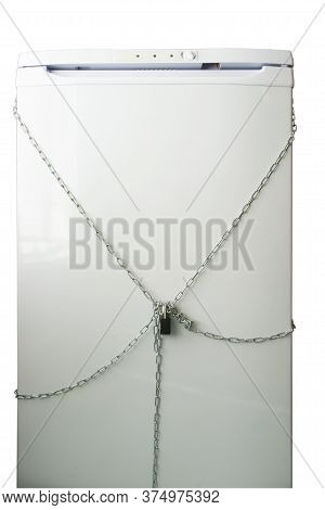 A Refrigerator Wrapped In A Metal Chain And Locked With A Padlock At Night.
