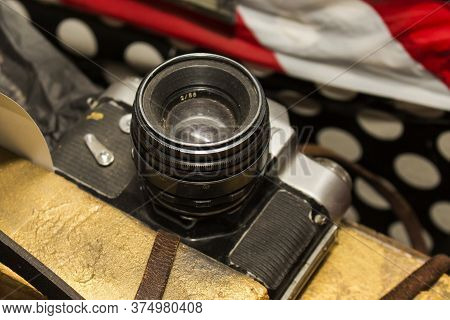 Film Camera Of The Old Model With A Black Metal Case And A Leather Strap