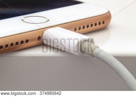 Calgary, Alberta. Canada July 5, 2020. Close Up Over View Of An Iphone Plus Charging With A Lightnin