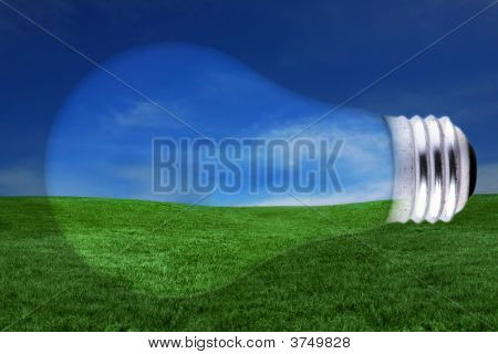 Concetto di energia con lampadina e paesaggio