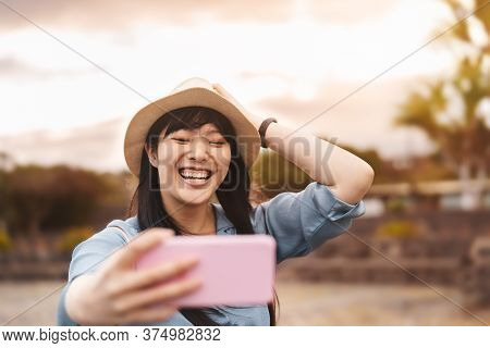 Happy Asian Girl Taking Selfie With Mobile Smartphone During Vacation - Travel Chinese Woman Having 
