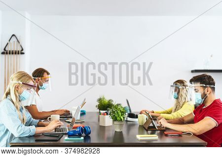 Young People Working In Co-working Creative Space Wearing Surgical Mask Protection For Preventing Co