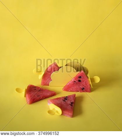 Watermelon Slices On An Ice Cream Stick On A Yelloow Background. Creative Idea Top View