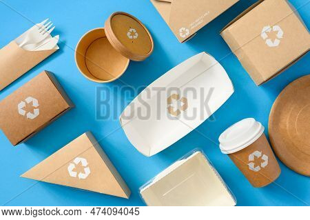 Eco-friendly Disposable Paper Tableware With A Recycling Sign On A Blue Background. Zero Waste And R