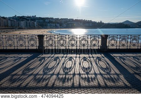 Walking On Promenade Along White Sandy La Concha Beach In Central Part Of Donostia Or San Sebastian