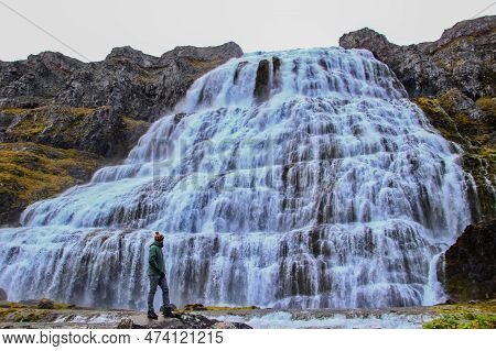Man Looking Of Dynjandi, Also Called Fjallfoss, A Huge Waterfall In Vestfirdir.