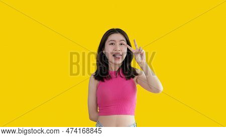 Young Asian Woman Making Two Thumbs Up Gesture Showing Joy And Fun, Symbol Of Good Friendship, Popul