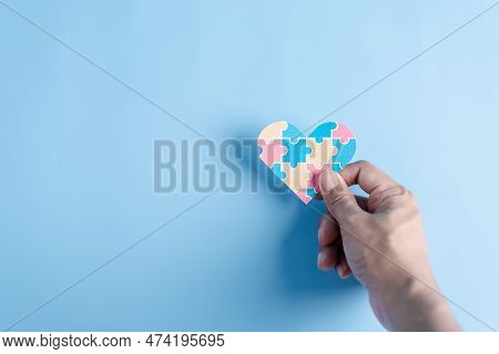 Hand Holding Awareness Heart Jigsaw Puzzle, Color Puzzle Symbol Of Awareness For Autism Spectrum Dis
