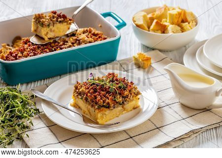 Portion Of Sunday Breakfast Strata With Ground Beef, Mushrooms, Cheese, Green Onion And Thyme In Bak