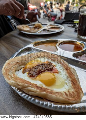 Roti Sarang Burung Served With Different Gravies. It Is Pratha Looks Like Bird Nest With Half Cook E