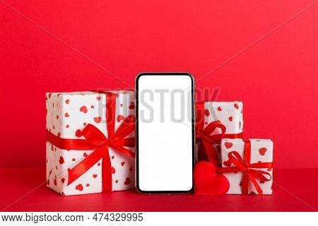 Mobile Phone With Blank Screen On Colored Background With Hearts, Calendar And Gift Box, Valentine D
