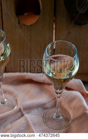 Glasses Of Sparkling White Wine Champagne Or Cava With Bubbles And Classic Wooden Champagne Pupitre